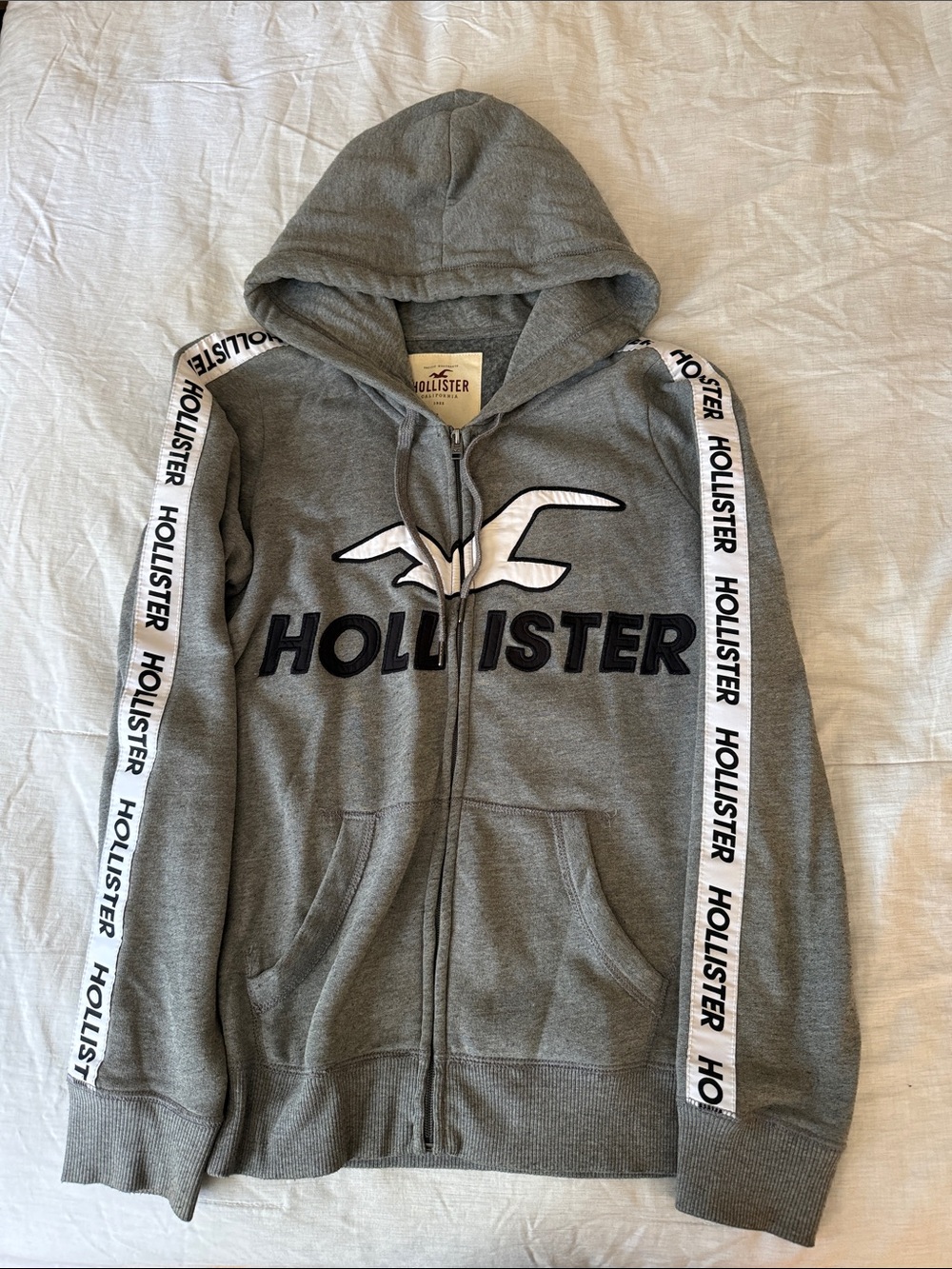 Hollister Gray Zip-Up Hoodie with White Logo and Black Text